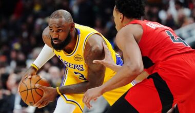 Los Angeles Lakers' LeBron James, left, is guarded by Toronto Raptors' Scottie Barnes (4) during second-half NBA basketball game action in Toronto, Thursday, Dec. 4, 2025. (Frank Gunn/The Canadian Press via AP)