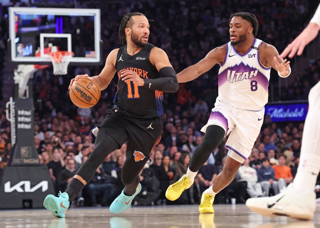 New York Knicks guard Jalen Brunson #11 drives to the basket as Utah Jazz guard Isaiah Collier #8 defends during the first quarter.