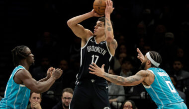 Brooklyn Nets forward Michael Porter Jr. (17) looks to shoot between Charlotte Hornets guard Sion James, left, and forward Miles Bridges (0) during the second half of an NBA basketball game Monday, Dec. 1, 2025, in New York. (AP Photo/Adam Hunger)