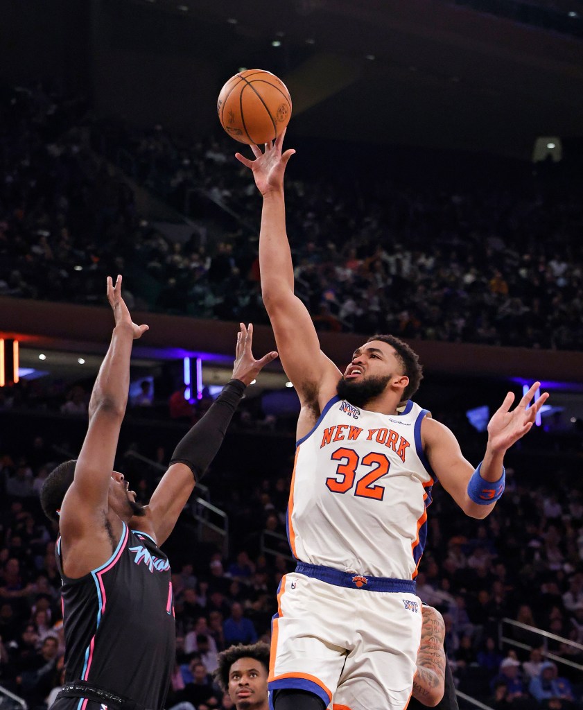 Karl-Anthony Towns (32) puts up a shot over Miami Heat center Bam Adebayo (13) during the second half when the New York Knicks played the Miami Heat Sunday, December 21, 2025.