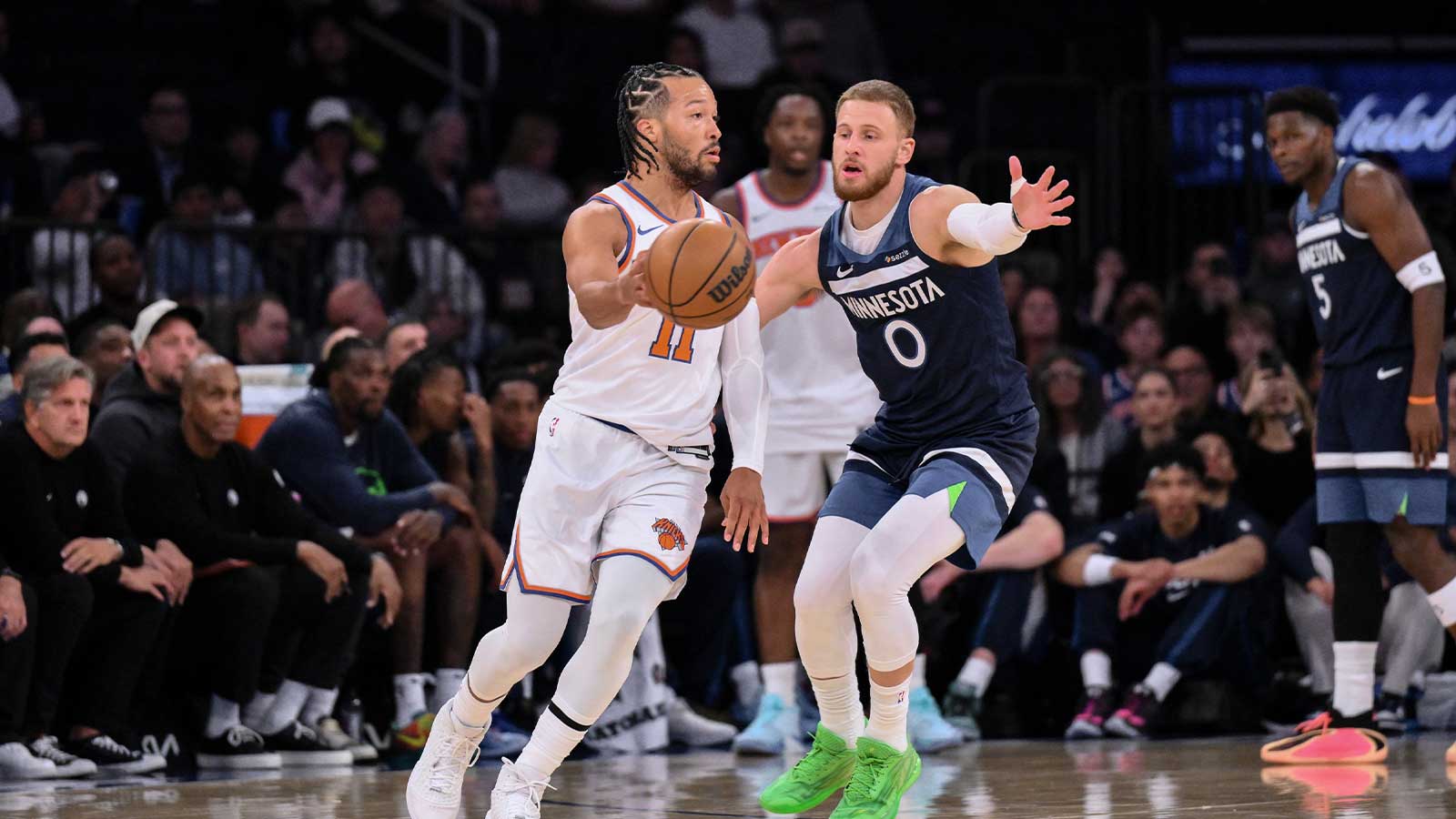 Oct 9, 2025; New York, New York, USA; New York Knicks guard Jalen Brunson (11) passes the ball as Minnesota Timberwolves guard Donte Divincenzo defends during the first half at Madison Square Garden. Mandatory Credit: John Jones-Imagn Images