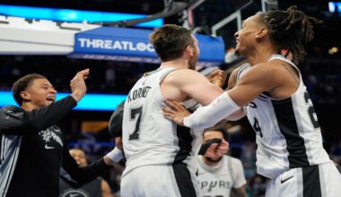 San Antonio Spurs center Luke Kornet (7) celebrates with teammates after blocking a shot by Orlando Magic forward Franz Wagner to win an NBA basketball game, Wednesday, Dec. 3, 2025, in Orlando, Fla. (AP Photo/John Raoux)