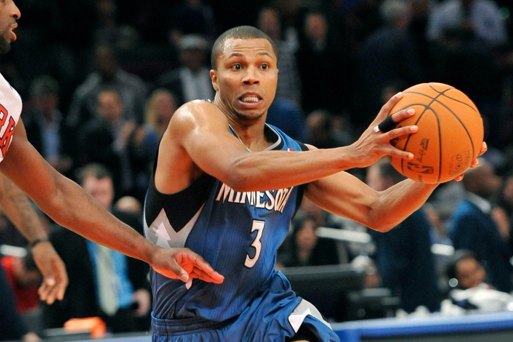 Sebastian Telfair holding a basketball while playing defense.