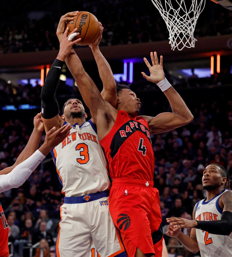 Toronto Raptors forward Scottie Barnes and New York Knicks guard Josh Hart jump for a rebound.