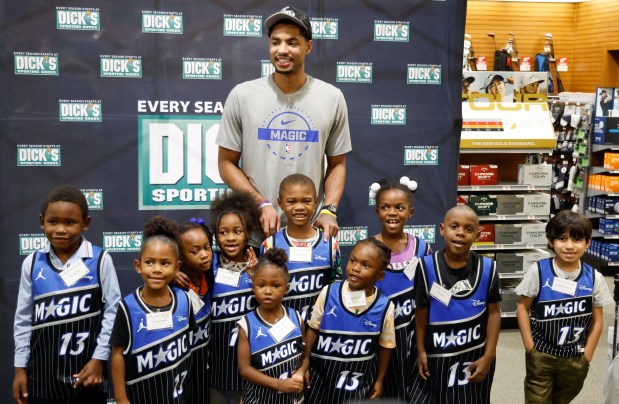 Orlando Magic small forward Jett Howard gets a picture taken with some young shoppers he hosted at a holiday shopping event for local youth at DICK'S Sporting Goods in Orlando on Tuesday, Dec. 2, 2025. Howard played along and helped 10 kids from the Alzheimer's Association as they shopped with a $150 gift card that they received, along with an Orlando Magic basketball that was gifted to them as they checked out at the registers. (Rich Pope/Orlando Sentinel)