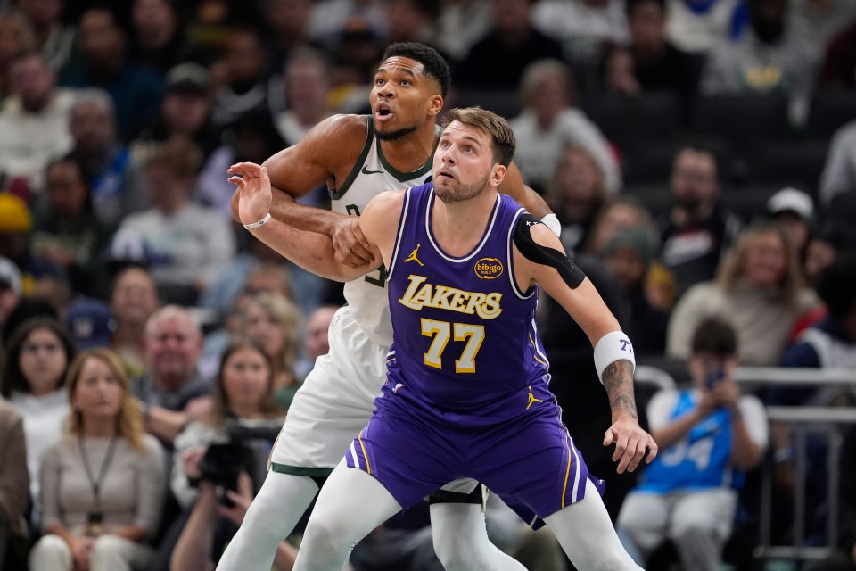 Luka Doncic #77 of the Los Angeles Lakers defends Giannis Antetokounmpo #34 of the Milwaukee Bucks