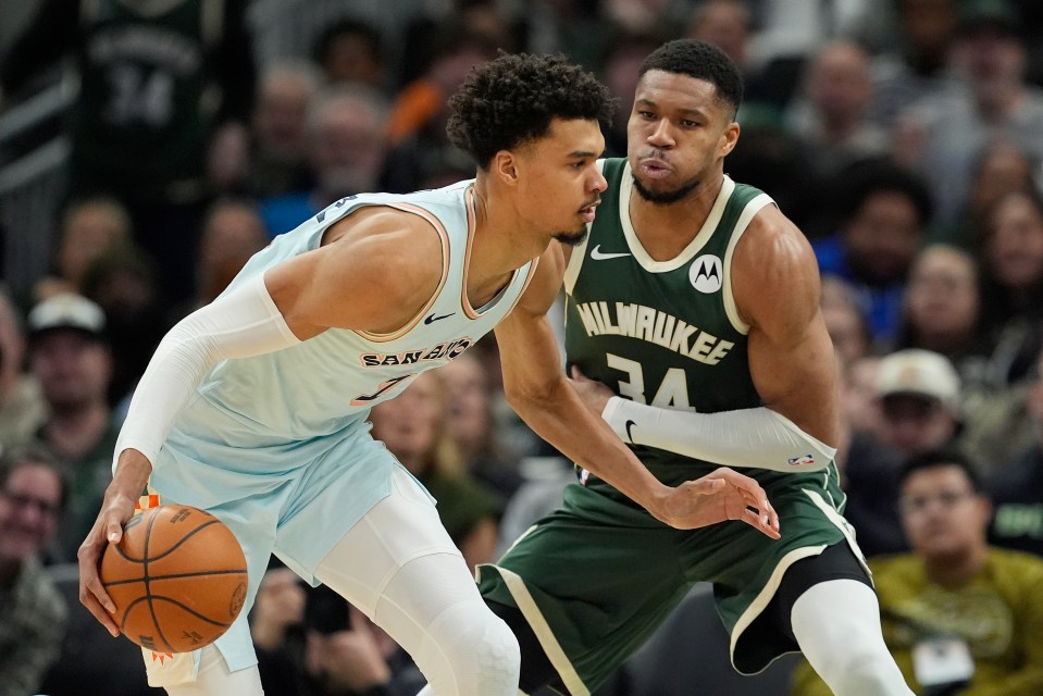 Giannis Antetokounmpo #34 of the Milwaukee Bucks defends Victor Wembanyama #1 of the San Antonio Spurs 