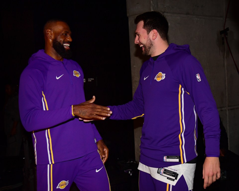 LeBron James #23 and Luka Doncic #77 of the Los Angeles Lakers high five during the game against the Utah Jazz during the game on November 23, 2025