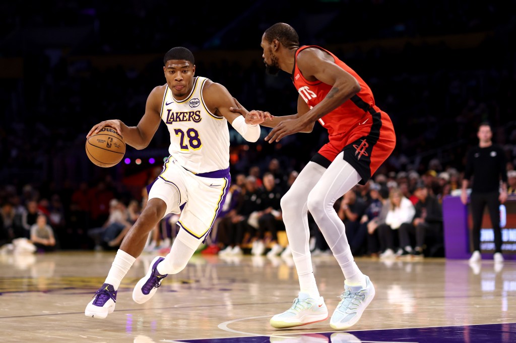 Rui Hachimura dribbles past Kevin Durant.