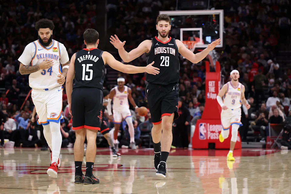 Jan 15, 2026; Houston, Texas, USA; Houston Rockets center Alperen Sengun (28) reacts with guard Reed Sheppard (15) after a play during the third quarter against the Oklahoma City Thunder at Toyota Center. Mandatory Credit: Troy Taormina-Imagn Images