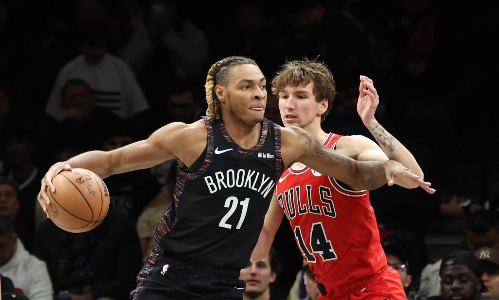 Noah Clowney #21 of the Brooklyn Nets drives pass Matas Buzelis #14 of the Chicago Bulls during the first quarter.