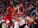 Giannis Antetokounmpo of the Milwaukee Bucks controls the ball against Immanuel Quickley of the Toronto Raptors during a game earlier this season.