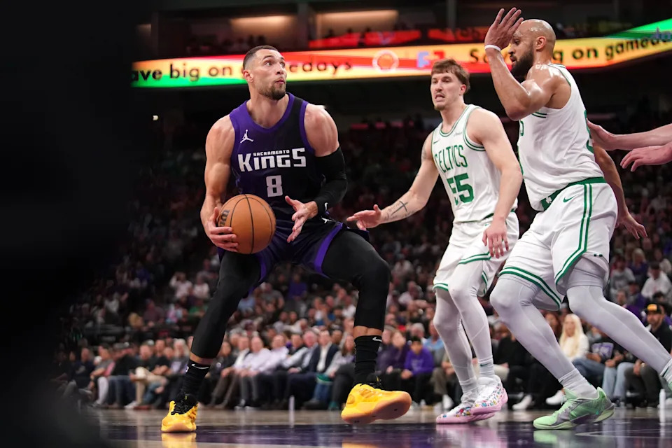 Mar 24, 2025; Sacramento, California, USA; Sacramento Kings guard Zach LaVine (8) drives to the hoop next to Boston Celtics guard Derrick White (9) in the fourth quarter at the Golden 1 Center. Mandatory Credit: Cary Edmondson-Imagn Images