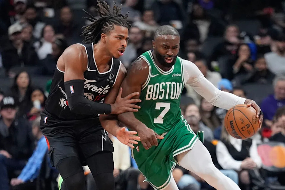 Dec 7, 2025; Toronto, Ontario, CAN; Toronto Raptors forward Collin Murray-Boyles (12) tries to slow up Boston Celtics forward Jaylen Brown (7) during the first half at Scotiabank Arena. Mandatory Credit: John E. Sokolowski-Imagn Images