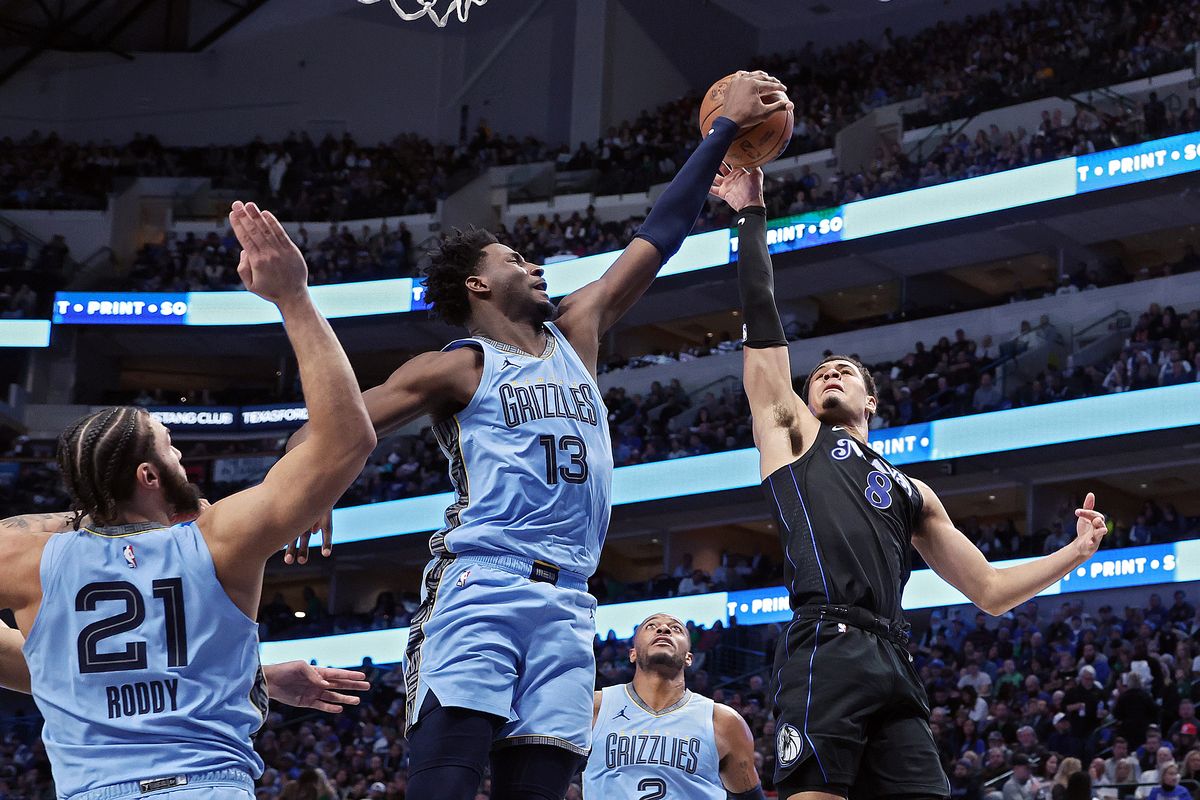 DALLAS, TEXAS - DECEMBER 01: Jaren Jackson Jr. #13 of the Memphis Grizzlies blocks the shot of Josh Green #8 of the Dallas Mavericks in the first half at American Airlines Center on December 01, 2023 in Dallas, Texas.