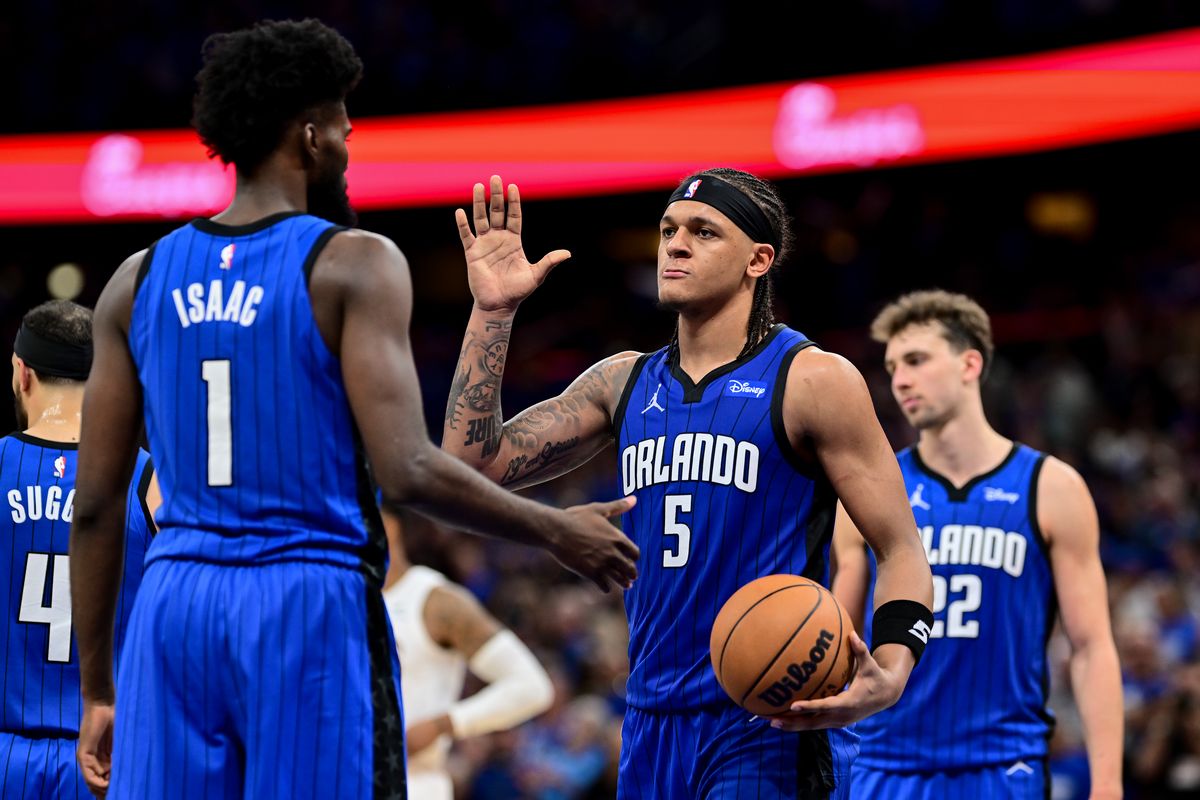 ORLANDO, FLORIDA - MAY 03: Paolo Banchero #5 of the Orlando Magic high-fives teammate Jonathan Isaac #1 after a play against the Cleveland Cavaliers during the fourth quarter in Game Six of the Eastern Conference First Round Playoffs at Kia Center on May 03, 2024 in Orlando, Florida.