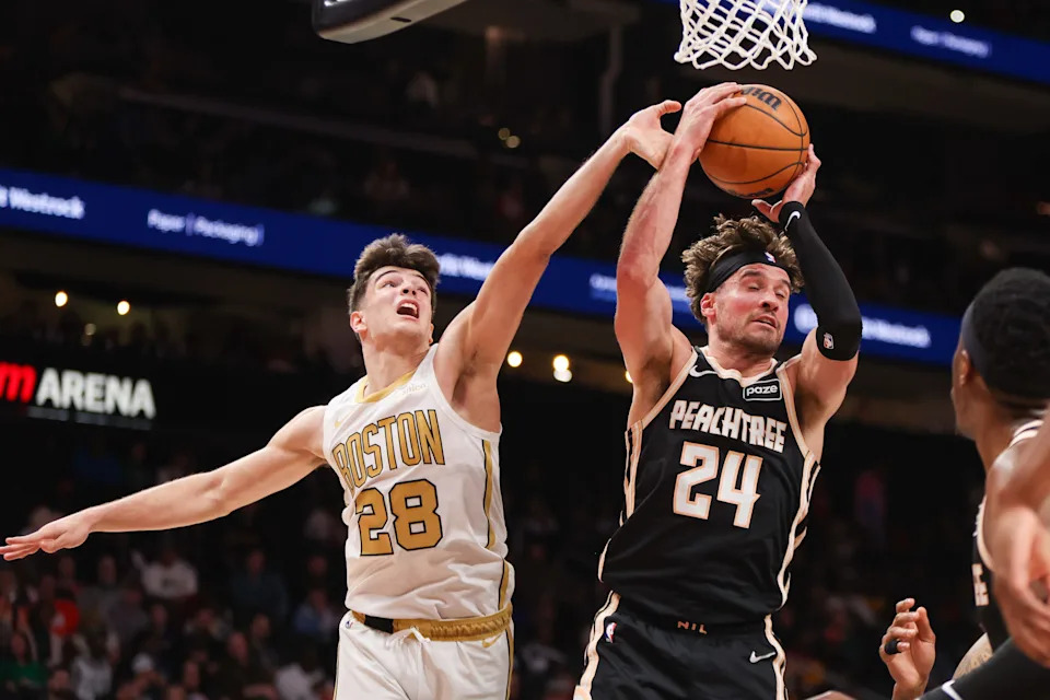 Jan 17, 2026; Atlanta, Georgia, USA; Atlanta Hawks forward Corey Kispert (24) grabs a rebound past Boston Celtics guard Hugo Gonzalez (28) in the fourth quarter at State Farm Arena. Mandatory Credit: Brett Davis-Imagn Images