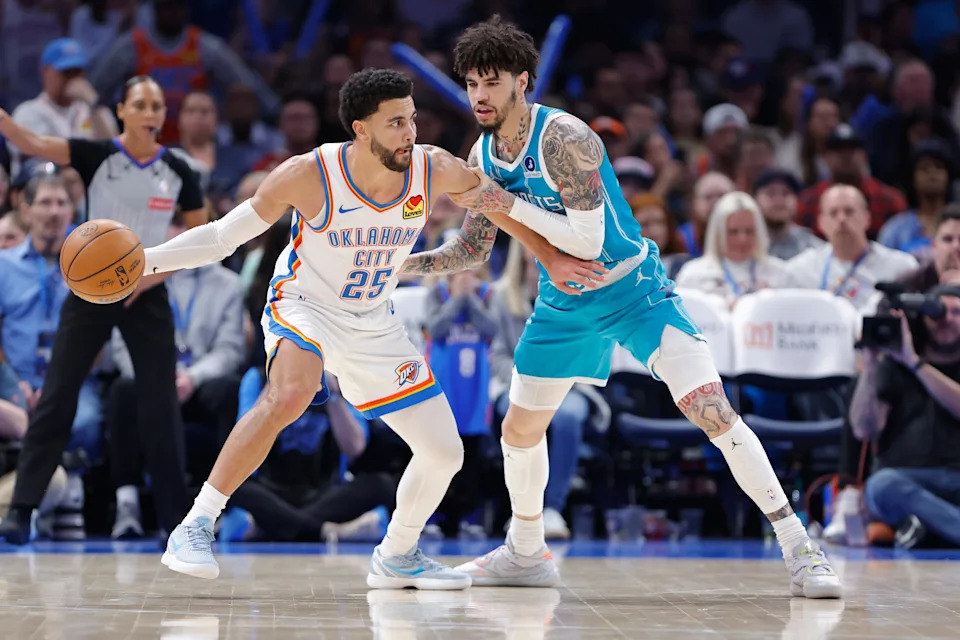 Jan 5, 2026; Oklahoma City, Oklahoma, USA; Oklahoma City Thunder guard Ajay Mitchell (25) drives against Charlotte Hornets guard Lamelo Ball (1) during the second half at Paycom Center. Mandatory Credit: Alonzo Adams-Imagn Images