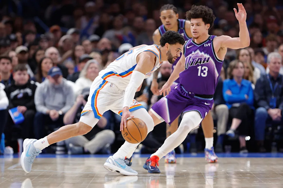 Jan 7, 2026; Oklahoma City, Oklahoma, USA; Oklahoma City Thunder guard Ajay Mitchell (25) drives to the basket as Utah Jazz guard Walter Clayton Jr. (13) defends during the second half at Paycom Center. Mandatory Credit: Alonzo Adams-Imagn Images