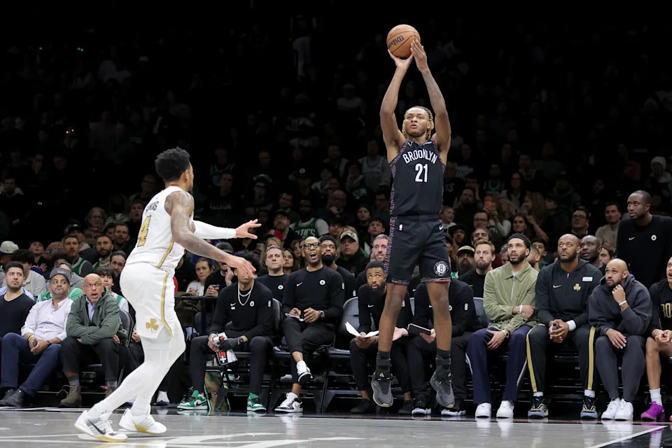 Jan 23, 2026; Brooklyn, New York, USA; Brooklyn Nets forward Noah Clowney (21) shoots a three point shot against Boston Celtics guard Anfernee Simons (4) during the fourth quarter at Barclays Center. Mandatory Credit: Brad Penner-Imagn Images