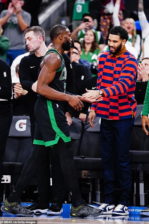 Tatum greets Jaylen Brown, who has put up MVP-caliber numbers in Tatum's absence