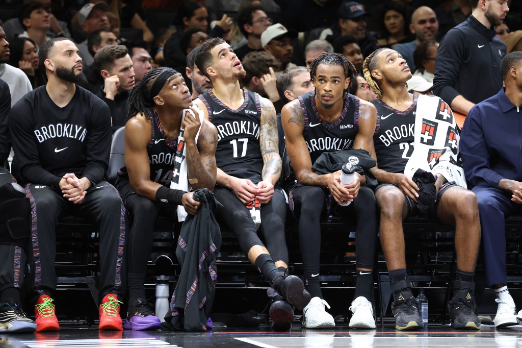 Terance Mann #14 of the Brooklyn Nets along with Michael Porter Jr. #17 of the Brooklyn Nets, Nic Claxton #33 of the Brooklyn Nets and Noah Clowney #21 of the Brooklyn Nets react on the bench during the fourth quarter.