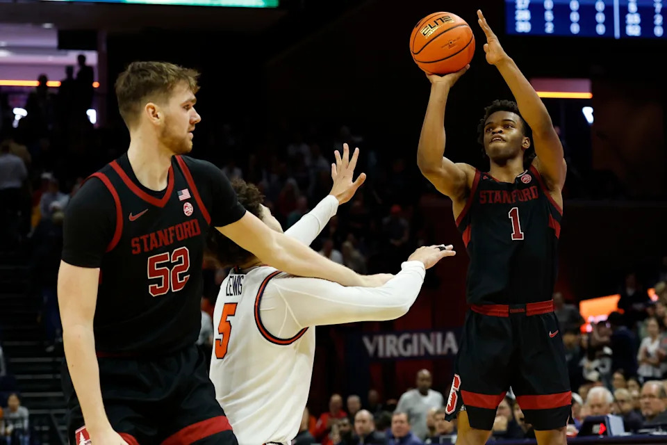 Jan 10, 2026; Charlottesville, Virginia, USA; Stanford Cardinal guard Ebuka Okorie (1) shoots the ball as Virginia Cavaliers guard Sam Lewis (5) defends in the first half at John Paul Jones Arena. Mandatory Credit: Geoff Burke-Imagn Images
