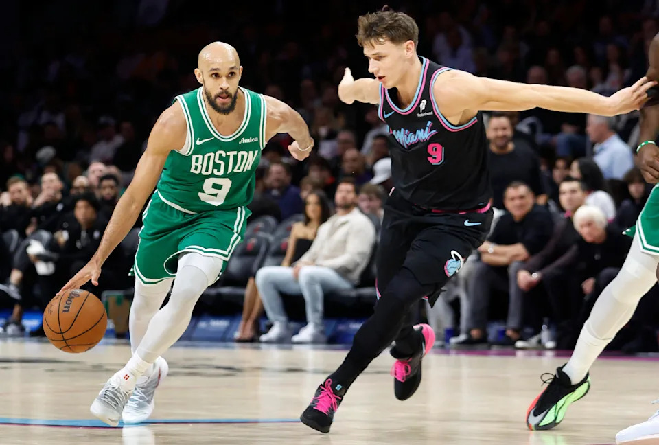 Jan 15, 2026; Miami, Florida, USA; Boston Celtics guard Derrick White (9) dribbles the ball past Miami Heat guard Pelle Larsson (9) during the second half at Kaseya Center. Mandatory Credit: Rhona Wise-Imagn Images