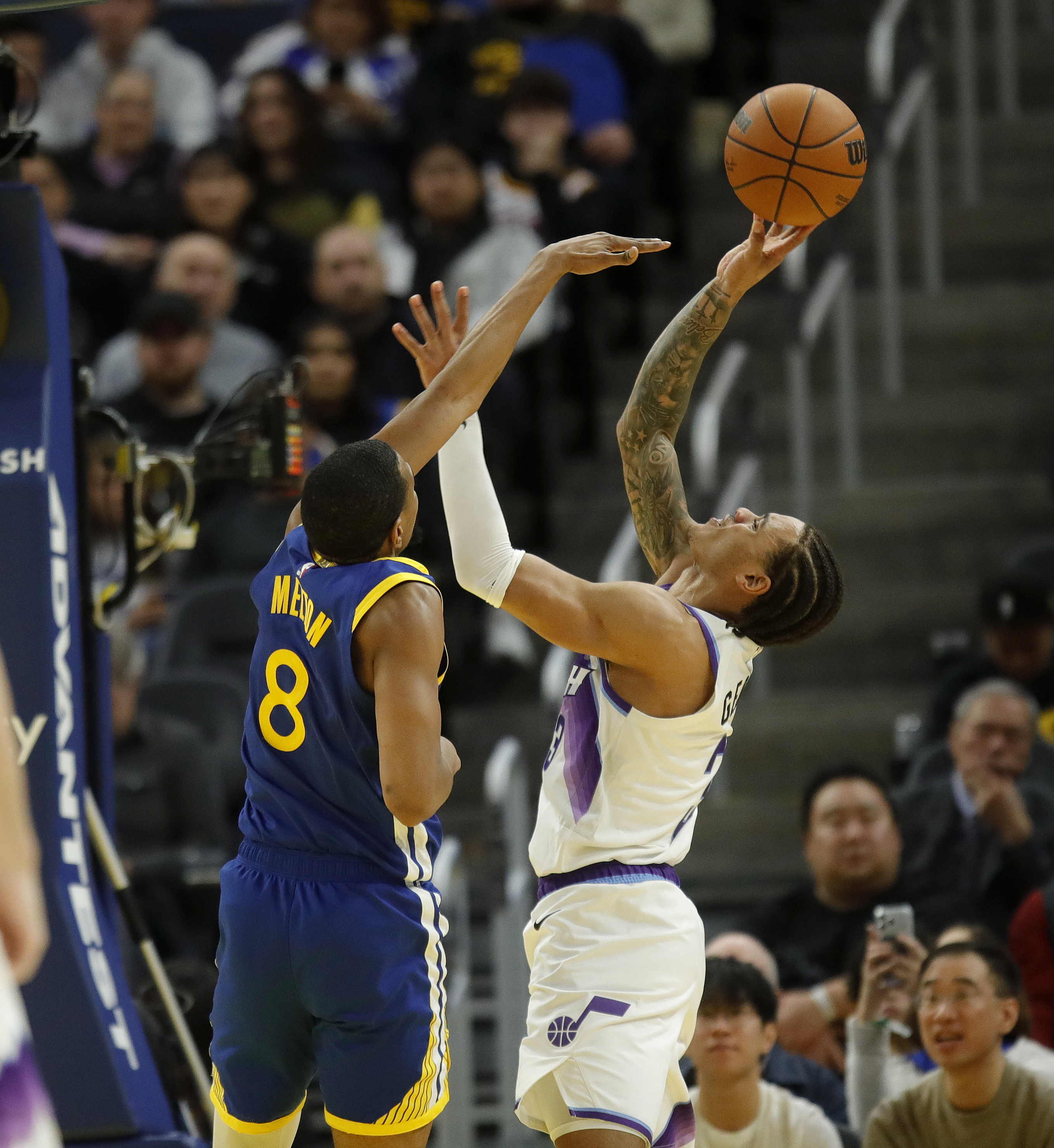 Utah Jazz's Keyonte George #3 shoots as heâs guarded by...