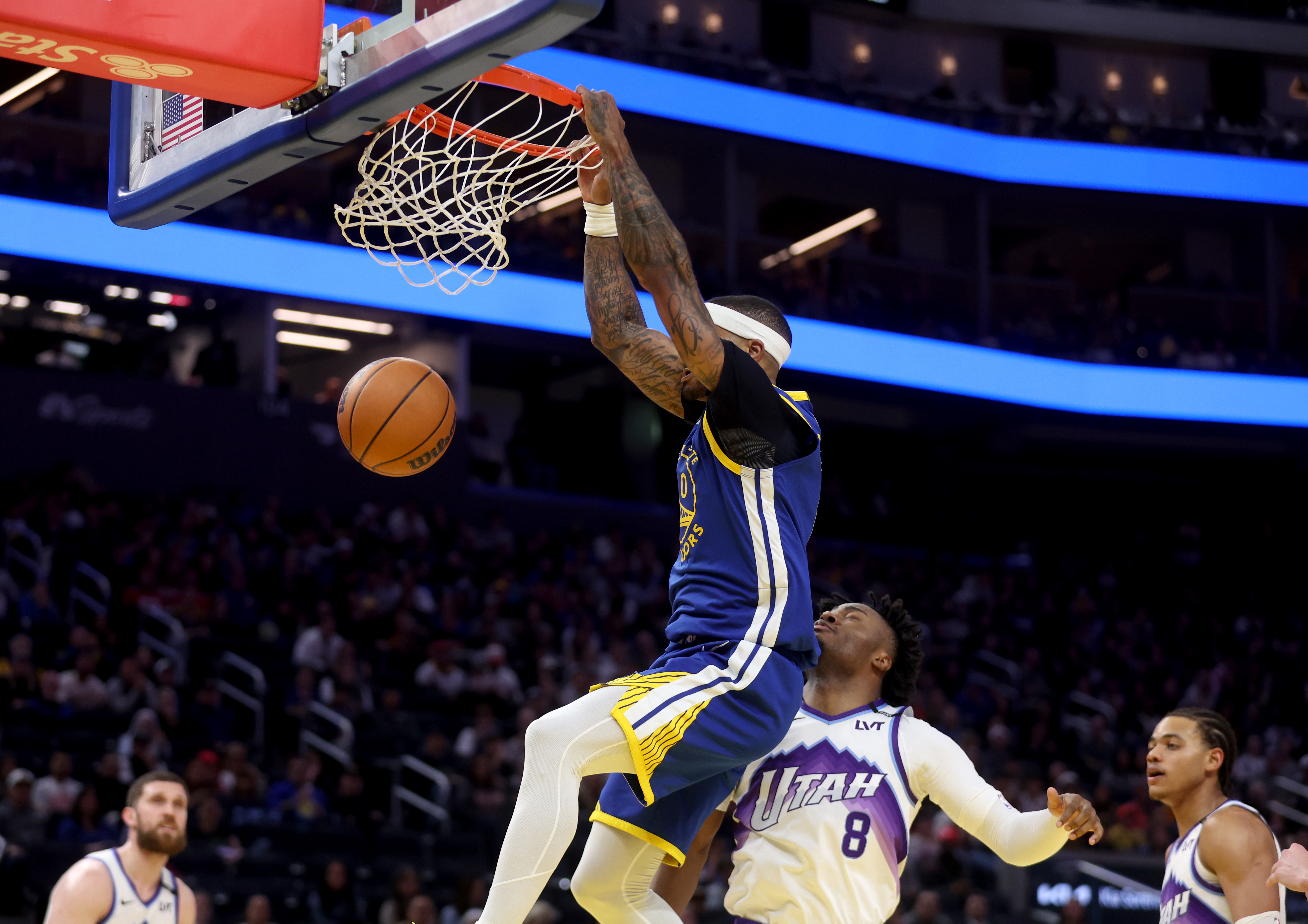 Golden State Warriors' Gary Payton II #0 dunks past Utah...
