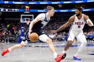 Dallas Mavericks forward Cooper Flagg (32) drives to the lane as he’s guarded by...
