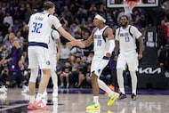 Dallas Mavericks guard Brandon Williams (10) celebrates with Dallas Mavericks forward Cooper...