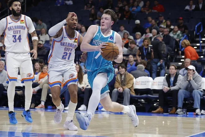 Jan 5, 2026; Oklahoma City, Oklahoma, USA; Charlotte Hornets guard Kon Knueppel (7) drives to the basket past Oklahoma City Thunder guard Aaron Wiggins (21) during the second half at Paycom Center.