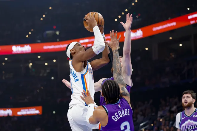Jan 7, 2026; Oklahoma City, Oklahoma, USA; Oklahoma City Thunder guard Shai Gilgeous-Alexander (2) goes up for a basket as Utah Jazz guard Keyonte George (3) defends during the first quarter at Paycom Center. Mandatory Credit: Alonzo Adams-Imagn Images