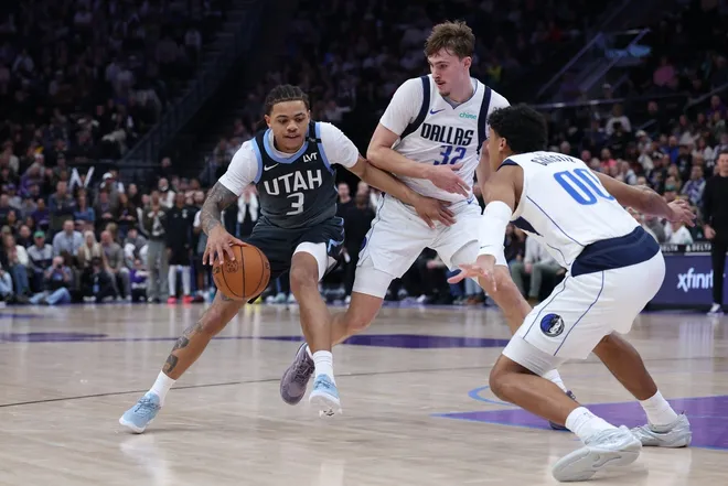 Jan 8, 2026; Salt Lake City, Utah, USA; Utah Jazz guard Keyonte George (3) drives to the basket against Dallas Mavericks forward Cooper Flagg (32) and guard Max Christie (00) during the second half at Delta Center.