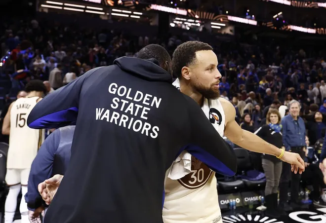Jan 9, 2026; San Francisco, California, USA; Golden State Warriors forward Draymond Green (23) and guard Stephen Curry (30) hug after the game against the Sacramento Kings at Chase Center.