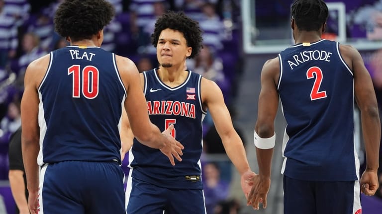Arizona guard Brayden Burries (5) celebrates a play with teammates...
