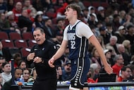 Dallas Mavericks assistant coach Frank Vogel, left, yells to Cooper Flagg (32) during the...