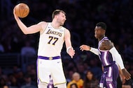 Los Angeles Lakers guard Luka Doncic (77) shields the ball from Sacramento Kings guard...