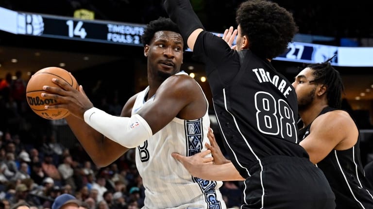 Memphis Grizzlies forward Jaren Jackson Jr. (8) handles the ball...