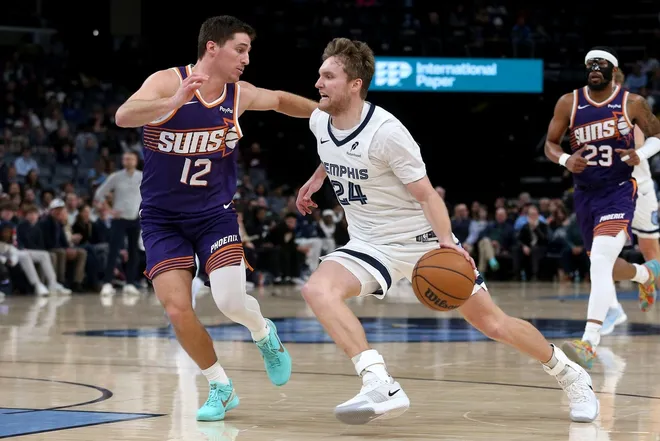 Jan 7, 2026; Memphis, Tennessee, USA; Memphis Grizzlies guard Cam Spencer (24) drives to the basket as Phoenix Suns guard Collin Gillespie (12) defends during the fourth quarter at FedExForum.