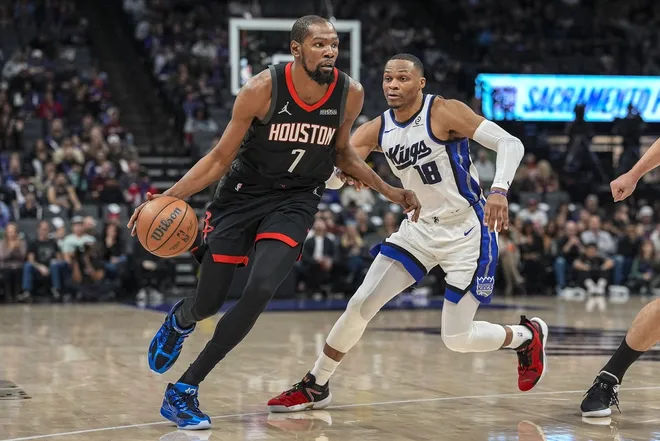 Jan 11, 2026; Sacramento, California, USA; Houston Rockets forward Kevin Durant (7) dribbles against Sacramento Kings guard Russell Westbrook (18) during the fourth quarter at Golden 1 Center.