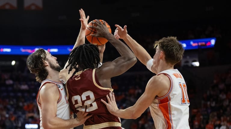 Clemson center Carter Welling (22) and forward Jake Wahlin (10)...