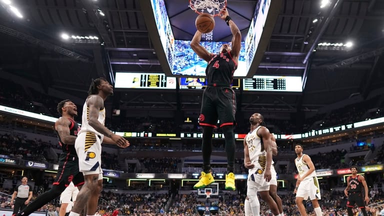 Toronto Raptors forward Scottie Barnes (4) dunks in front of...