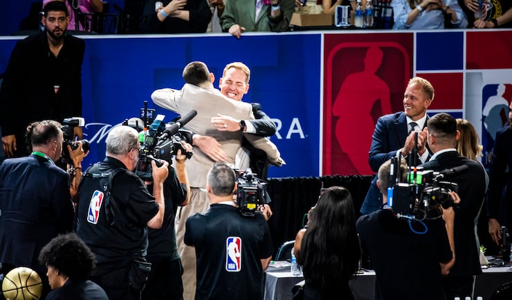 Egor Demin receives a hug from Travis Hansen after being selected No. 8 overall in the NBA draft by the Brooklyn Nets Wednesday, June 25, 2025.