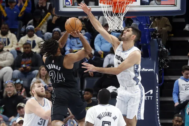 Jan 11, 2026; Memphis, Tennessee, USA; Memphis Grizzlies forward Santi Aldama (7) defends as Brooklyn Nets guard Cam Thomas (24) drives to the basket during the fourth quarter at FedExForum.