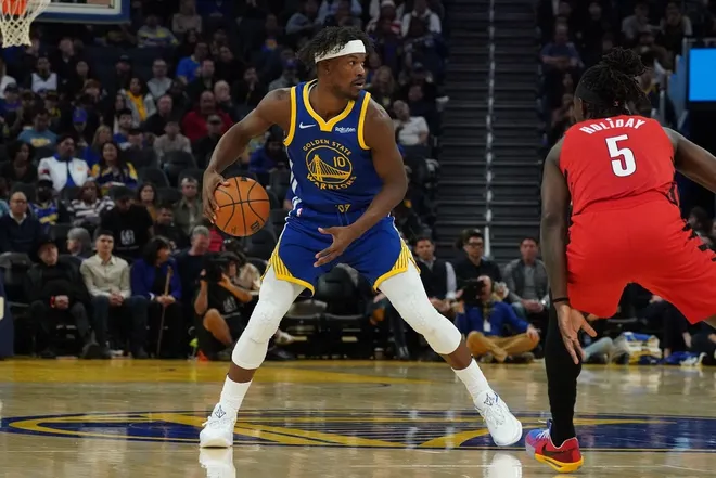 Jan 13, 2026; San Francisco, California, USA; Golden State Warriors forward Jimmy Butler III (10) dribbles against Portland Trail Blazers guard Jrue Holiday (5) in the third quarter at Chase Center.