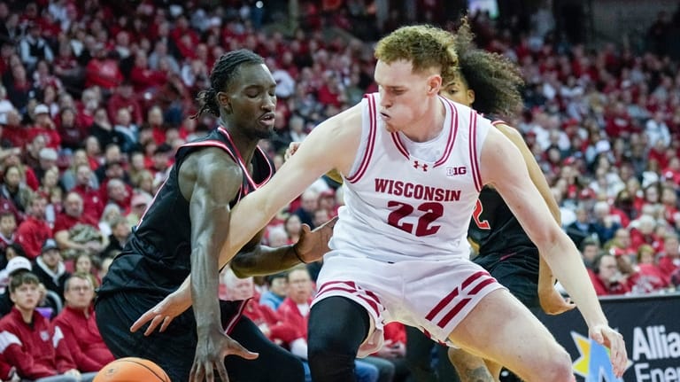 Rutgers' Chris Nwuli (11) knocks the ball loose from Wisconsin's...