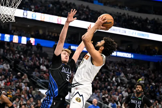 Jan 14, 2026; Dallas, Texas, USA; Denver Nuggets guard Jamal Murray (27) shoots the ball over Dallas Mavericks forward Cooper Flagg (32) during the first quarter at the American Airlines Center.