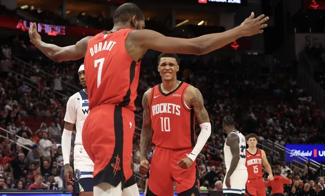 Jan 16, 2026; Houston, Texas, USA; Houston Rockets forward Jabari Smith Jr. (10) reacts to forward Kevin Durant (7) dunk against the Minnesota Timberwolves in the second half at Toyota Center.